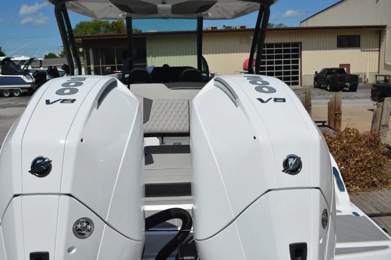Slide: The Image of 2026 Monterey Elite 30 OB boat with dual 600 V8 engines, docked outdoors. - 6