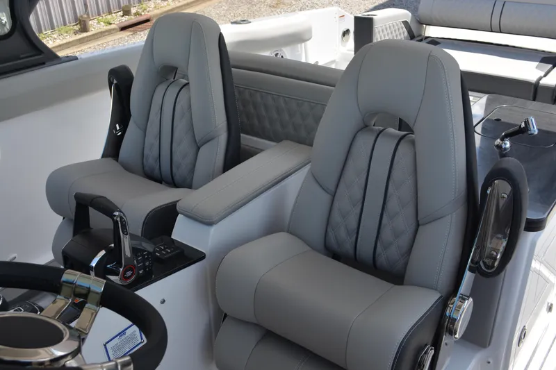 Slide: The Image of Luxurious cockpit seating in 2026 Monterey Elite 30 OB boat, featuring modern design and controls. - 8