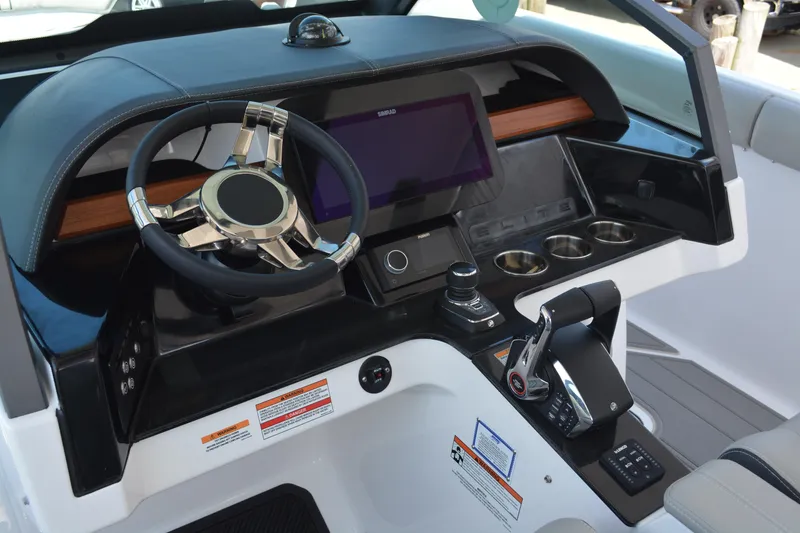 Slide: The Image of 2026 Monterey Elite 30 OB boat dashboard with steering wheel, touchscreen, and controls. - 9