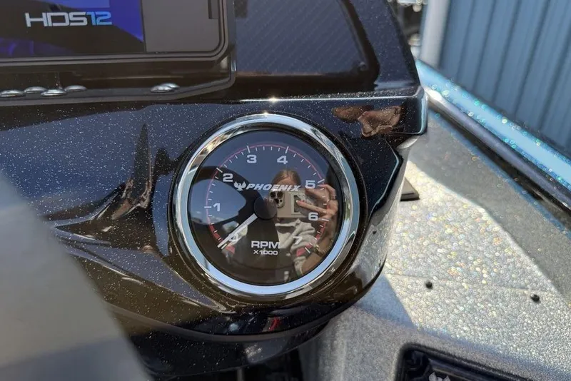 Slide: The Image of Close-up of 2026 Phoenix 20 XE RPM gauge on a boat dashboard. - 12