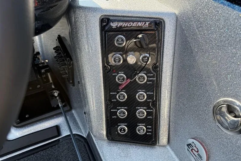 Slide: The Image of Control panel of 2026 Phoenix 20 XE boat with various switches and dials. - 16