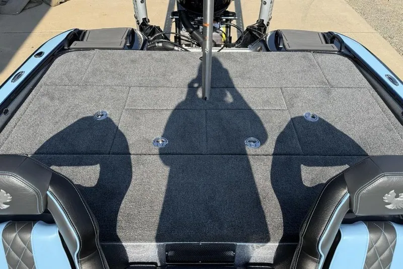 Slide: The Image of 2026 Phoenix 20 XE boat interior with gray carpet and black leather seats. - 17