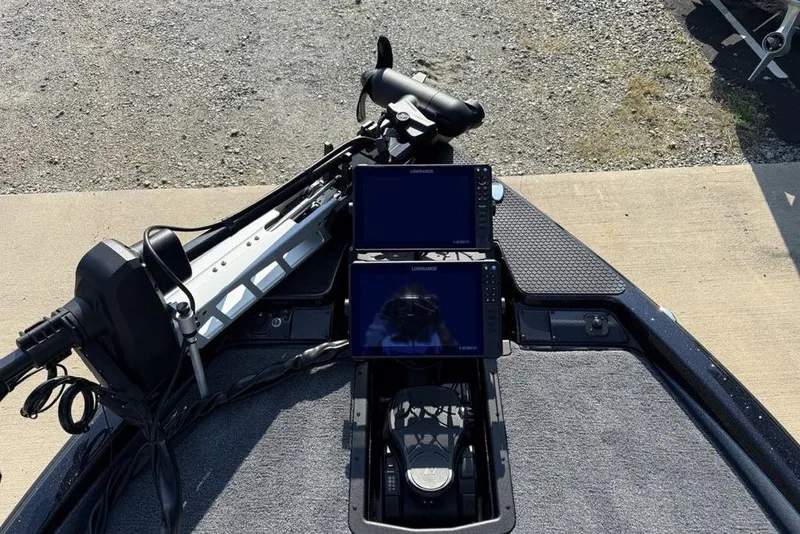 Slide: The Image of 2026 Phoenix 20 XE boat dashboard with dual Lowrance displays and trolling motor. - 6