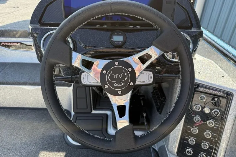 Slide: The Image of Steering wheel of 2026 Phoenix 20 XE boat with control panel and logo. - 8