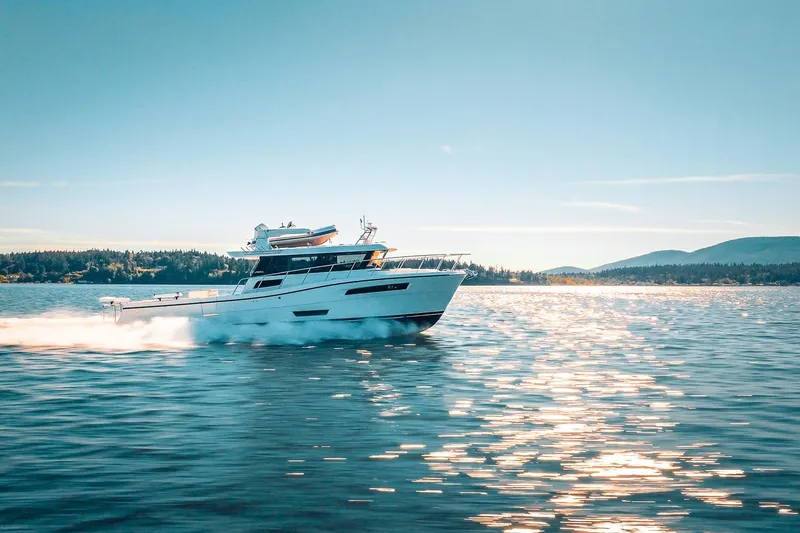 Slide: The Image of 2025 Lindell 48' yacht cruising on a sunny day, reflecting on calm waters. - 0