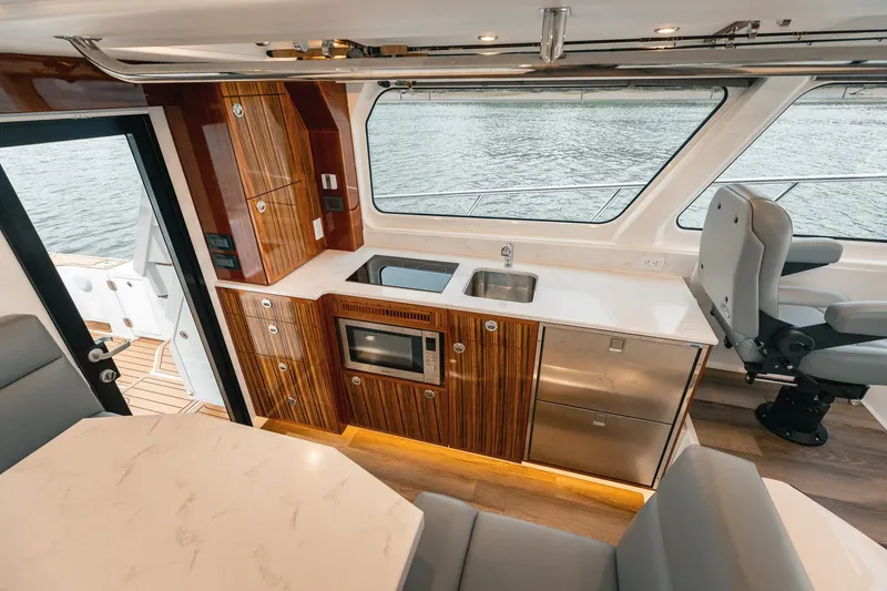 Slide: The Image of Luxurious 2025 Lindell 48' yacht interior with modern kitchen and seating area. - 10