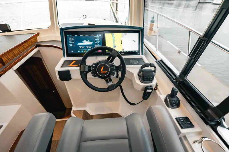 Slide: The Image of Modern helm of 2025 Lindell 48' yacht with advanced navigation system and controls. - 12