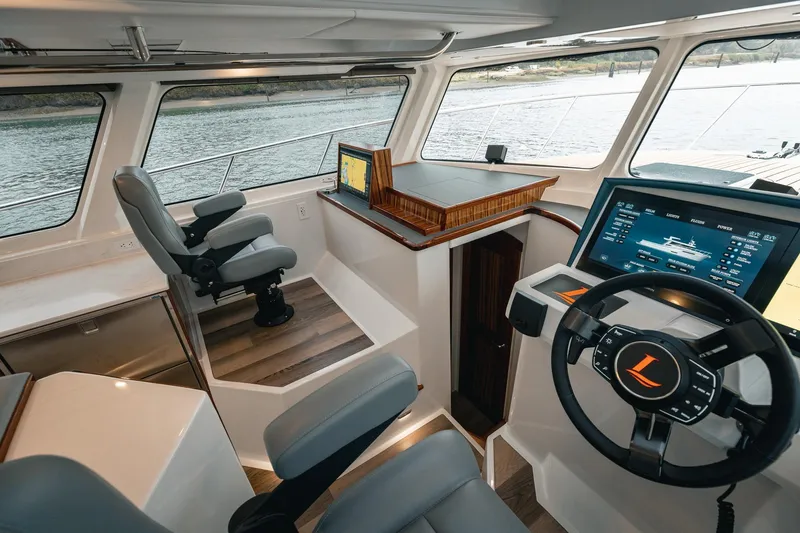 Slide: The Image of Modern helm of 2025 Lindell 48' yacht with advanced navigation systems and luxurious seating. - 13