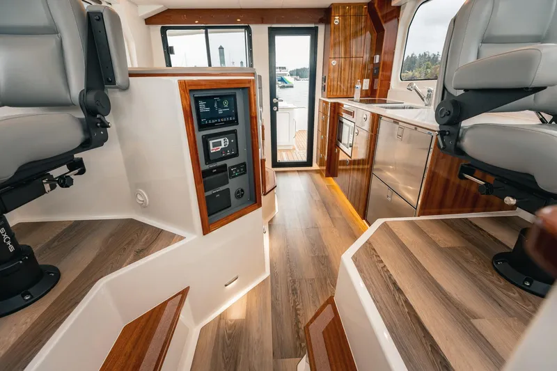Slide: The Image of Luxurious interior of 2025 Lindell 48' yacht with modern seating and sleek wood finishes. - 16