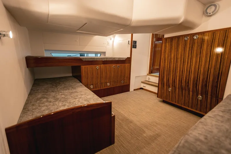 Slide: The Image of Luxurious interior of 2025 Lindell 48' yacht with elegant wood finishes and cozy sleeping area. - 21