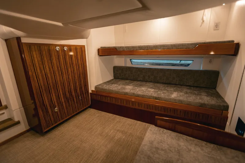 Slide: The Image of Luxurious interior of 2025 Lindell 48' yacht with cozy bunk beds and elegant wood finishes. - 22