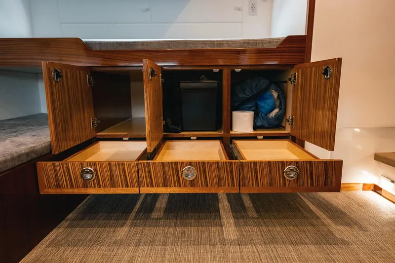 Slide: The Image of Luxurious storage cabinets in 2025 Lindell 48' yacht interior, featuring wood finish and ample space. - 24
