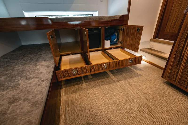 Slide: The Image of Luxurious interior storage of 2025 Lindell 48' yacht with open wooden cabinets and drawers. - 25