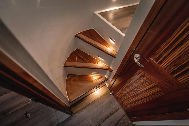 Slide: The Image of Luxurious wooden staircase with ambient lighting in 2025 Lindell 48' yacht interior. - 26