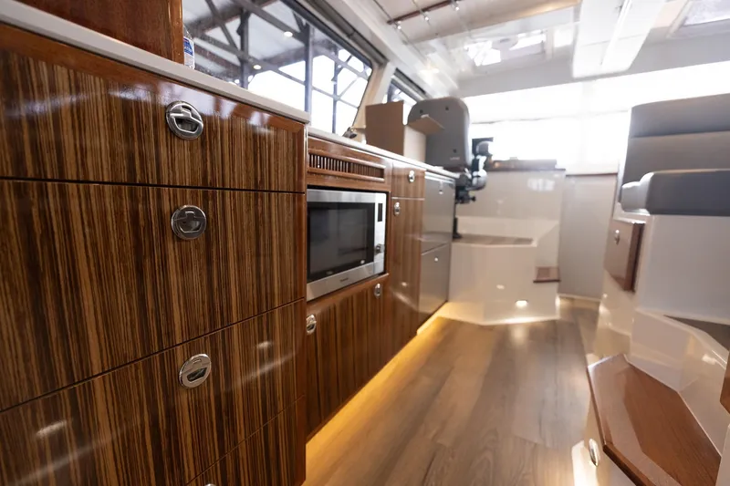 Slide: The Image of Luxurious interior of 2025 Lindell 48' yacht with modern wood cabinetry and sleek design. - 28