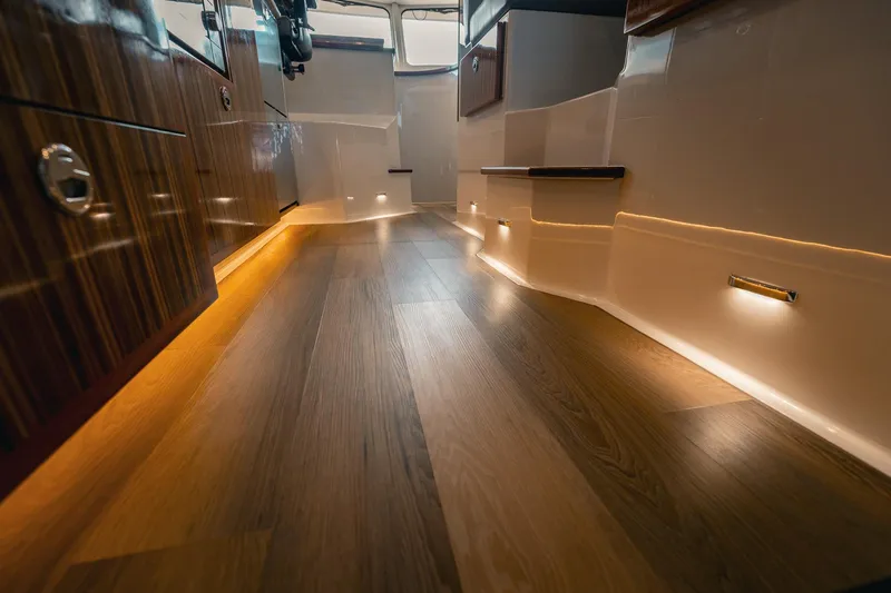 Slide: The Image of Luxurious interior of 2025 Lindell 48' yacht with elegant wood flooring and ambient lighting. - 30
