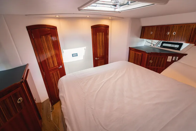 Slide: The Image of Luxurious 2025 Lindell 48' yacht cabin with elegant wood finishes and modern amenities. - 31