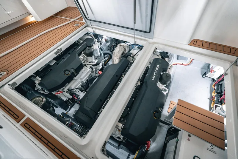 Slide: The Image of Engine room of 2025 Lindell 48' yacht, featuring dual engines and teak flooring. - 34