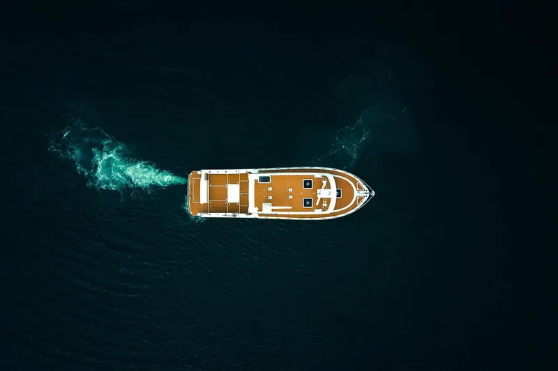 Slide: The Image of Aerial view of 2025 Lindell 48' yacht cruising on dark water. - 50