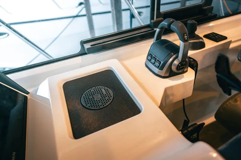 Slide: The Image of Control panel of 2025 Lindell 48' boat with joystick and speaker. - 59