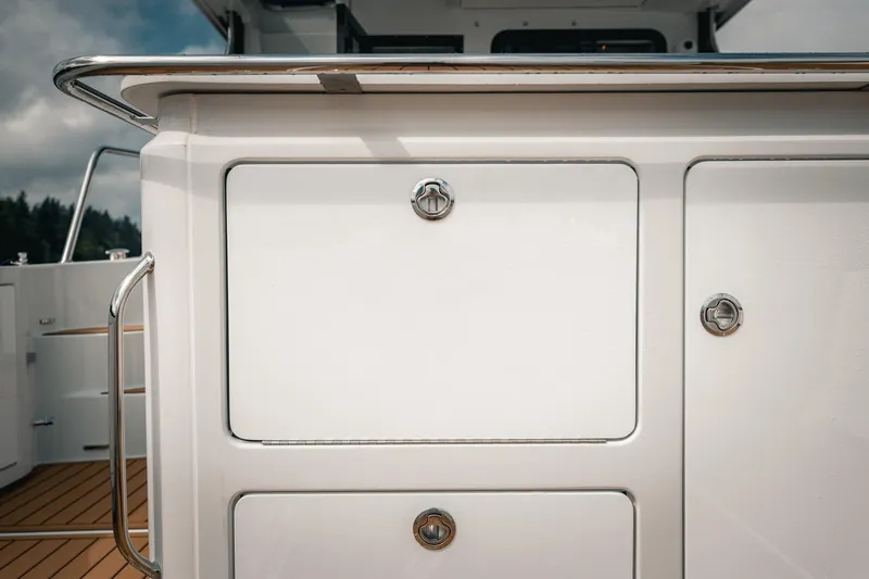 Slide: The Image of 2025 Lindell 48' yacht deck with sleek storage compartments and stainless steel handles. - 6