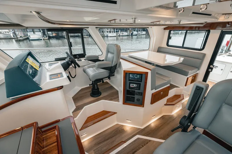 Slide: The Image of Luxurious interior of 2025 Lindell 48' yacht with modern helm and seating area. - 9
