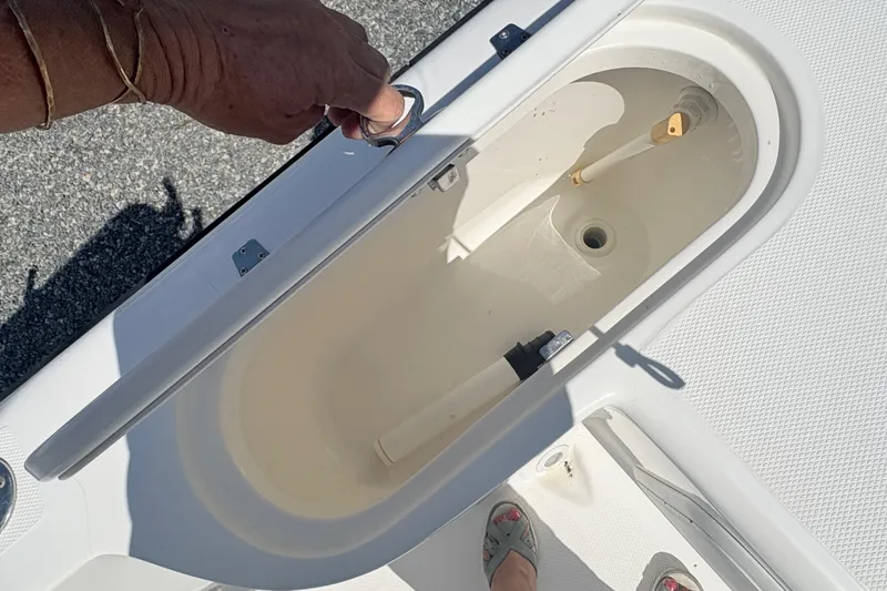 Slide: The Image of Open storage compartment on a 2002 Century 2300 Center Console boat. - 10