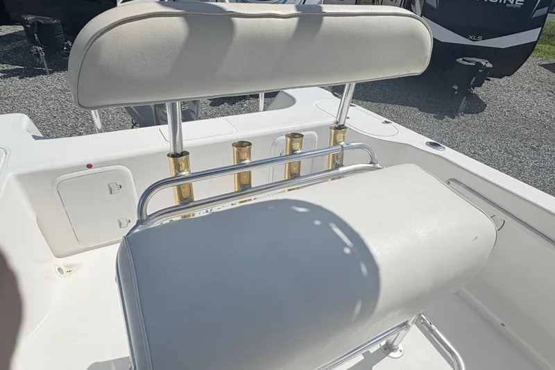 Slide: The Image of Century 2300 Center Console 2002 boat with white seating and rod holders. - 11