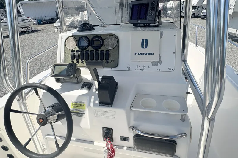 Slide: The Image of Century 2300 Center Console 2002 boat dashboard with steering wheel and navigation equipment. - 12