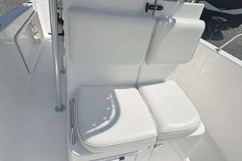 Slide: The Image of 2002 Century 2300 Center Console boat with white cushioned seating. - 18