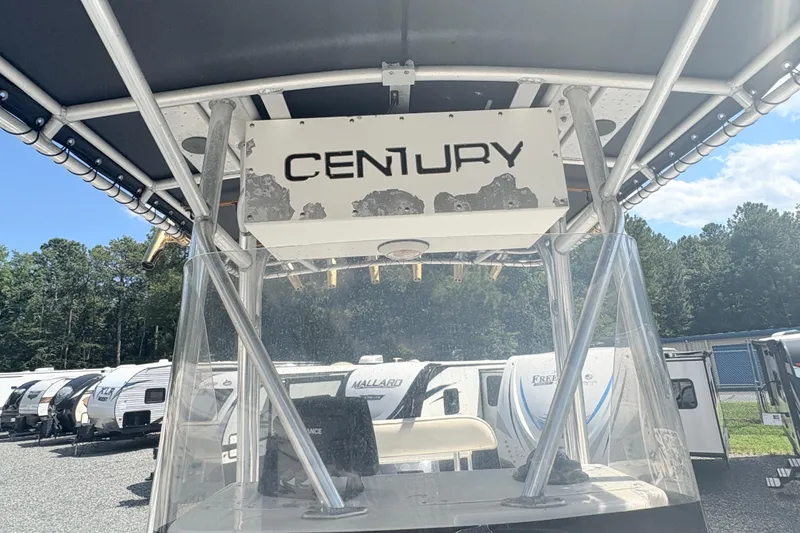 Slide: The Image of 2002 Century 2300 Center Console boat with canopy, parked near RVs. - 19