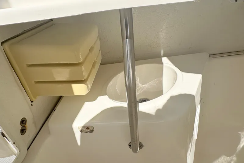 Slide: The Image of 2002 Century 2300 Center Console boat interior with sink and storage compartment. - 22