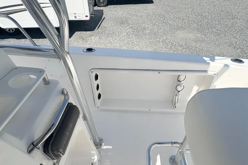 Slide: The Image of Century 2300 Center Console 2002 boat interior with seating and storage compartments. - 25