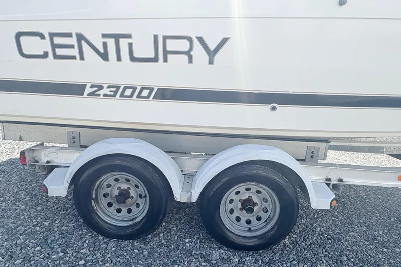 Slide: The Image of 2002 Century 2300 Center Console boat on trailer, side view. - 6