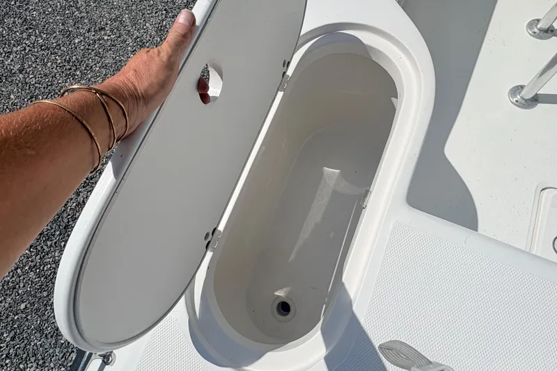Slide: The Image of Open storage compartment on a 2002 Century 2300 Center Console boat. - 8