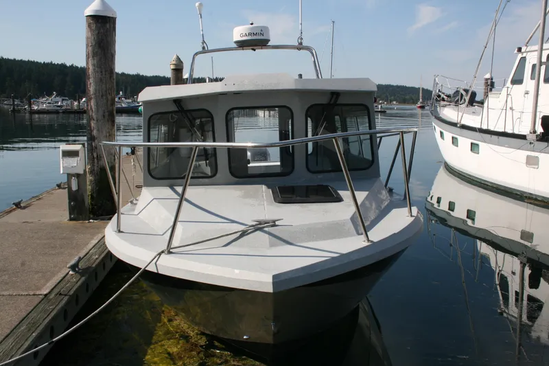 Slide: The Image of 2007 Harbercraft 2425 Pilot House boat docked at a marina. - 1