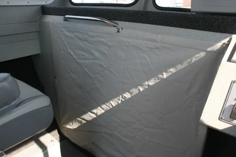 Slide: The Image of Interior of 2007 Harbercraft 2425 Pilot House with protective cover and seating. - 12
