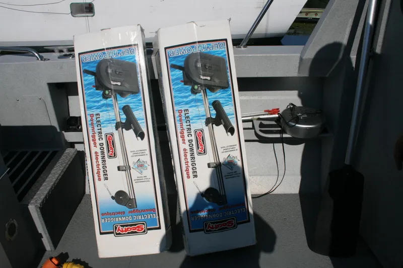 Slide: The Image of Boxes of Scotty electric downriggers on a 2007 Harbercraft 2425 Pilot House boat. - 17