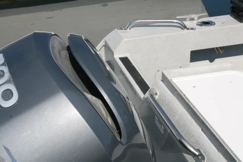 Slide: The Image of 2007 Harbercraft 2425 Pilot House boat with outboard motor, featuring sleek design and sturdy construction. - 19