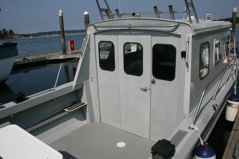 Slide: The Image of 2007 Harbercraft 2425 Pilot House boat docked at marina, rear view. - 21