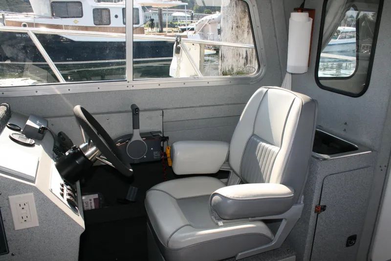 Slide: The Image of 2007 Harbercraft 2425 Pilot House interior with steering wheel and captain's chair. - 5