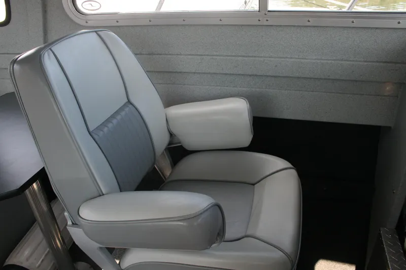 Slide: The Image of 2007 Harbercraft 2425 Pilot House interior with a comfortable gray captain's chair. - 6