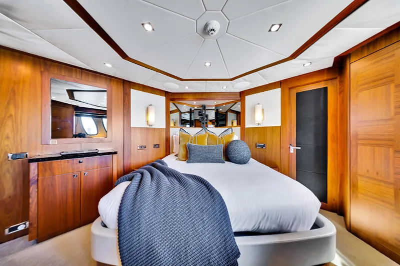 Slide: The Image of Luxurious bedroom interior on 2009 Sunseeker 37 Metre Yacht with elegant wood paneling. - 24