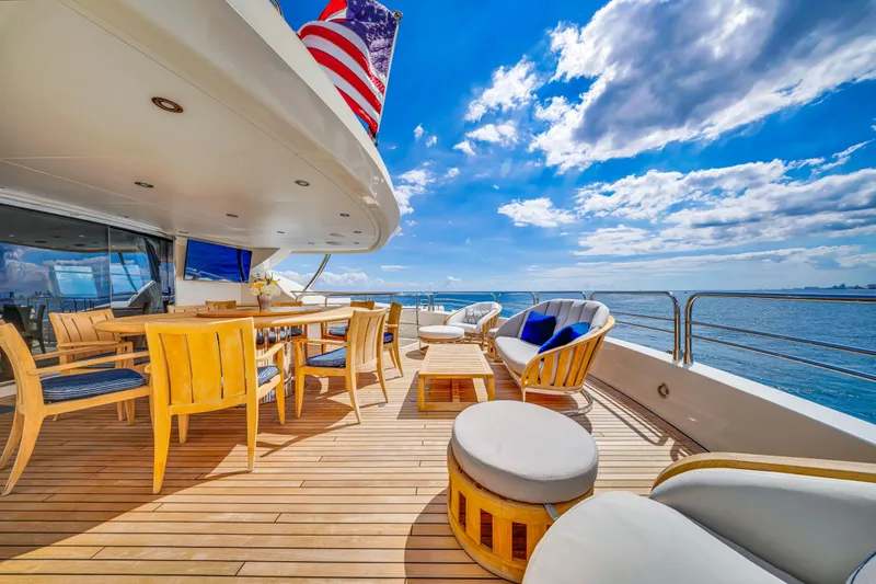 Slide: The Image of Luxurious Sunseeker 37 Metre Yacht deck with elegant seating, ocean view, and blue sky, 2009 model. - 37