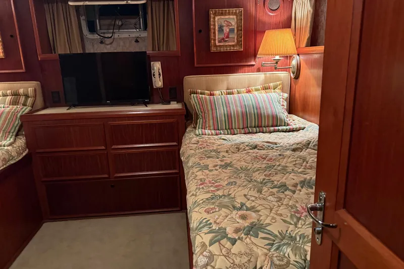 Slide: The Image of Cozy kitchen area in a 1980 Hatteras 42 LRC yacht with wooden cabinetry and modern appliances. - 11