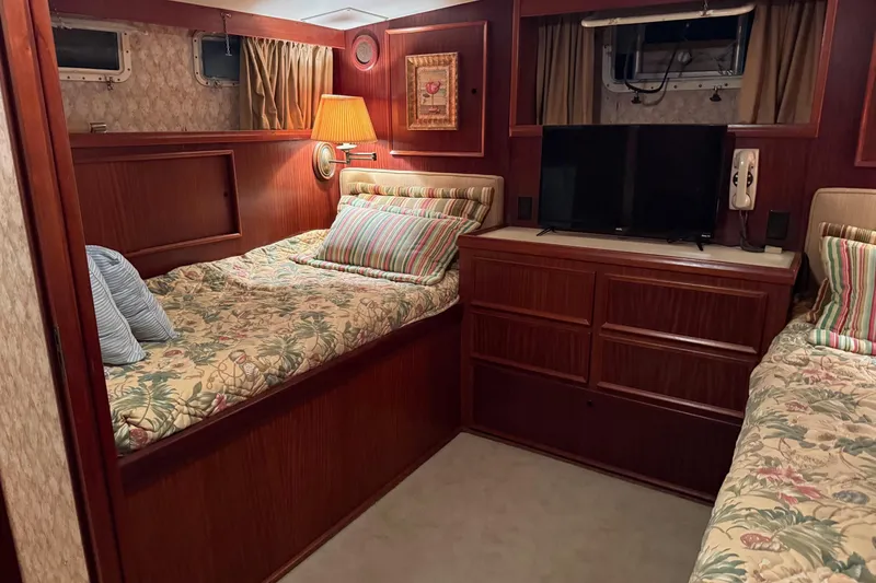 Slide: The Image of Interior of 1980 Hatteras 42 LRC yacht with cozy seating and wooden decor. - 12