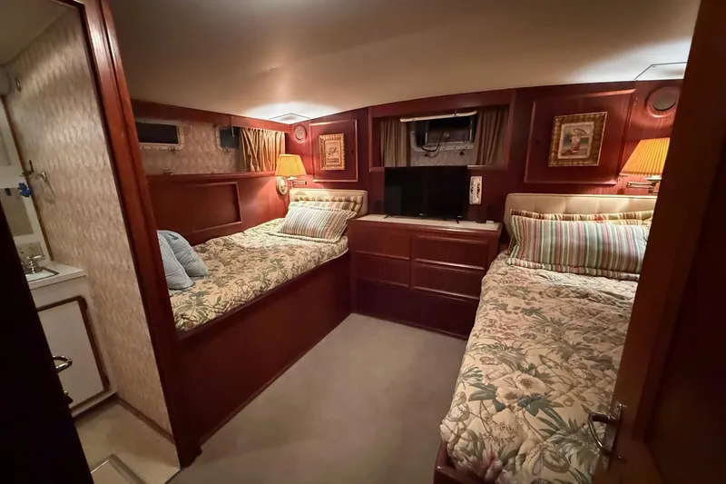 Slide: The Image of Interior of 1980 Hatteras 42 LRC yacht with cozy cabin and wooden furnishings. - 13