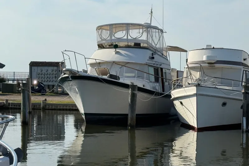 Slide: The Image of Interior of 1980 Hatteras 42 LRC yacht with wood paneling and seating area. - 17