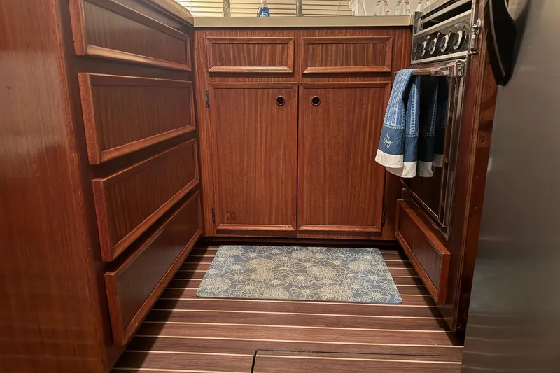 Slide: The Image of Cockpit view of 1980 Hatteras 42 LRC yacht with navigation screens at sunset. - 2