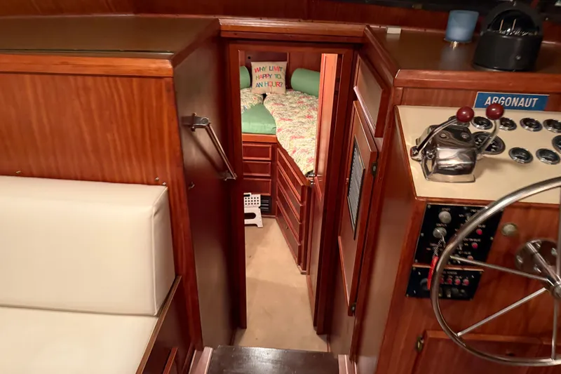Slide: The Image of Interior of 1980 Hatteras 42 LRC yacht, featuring helm, cabin, and cozy sleeping area. - 24